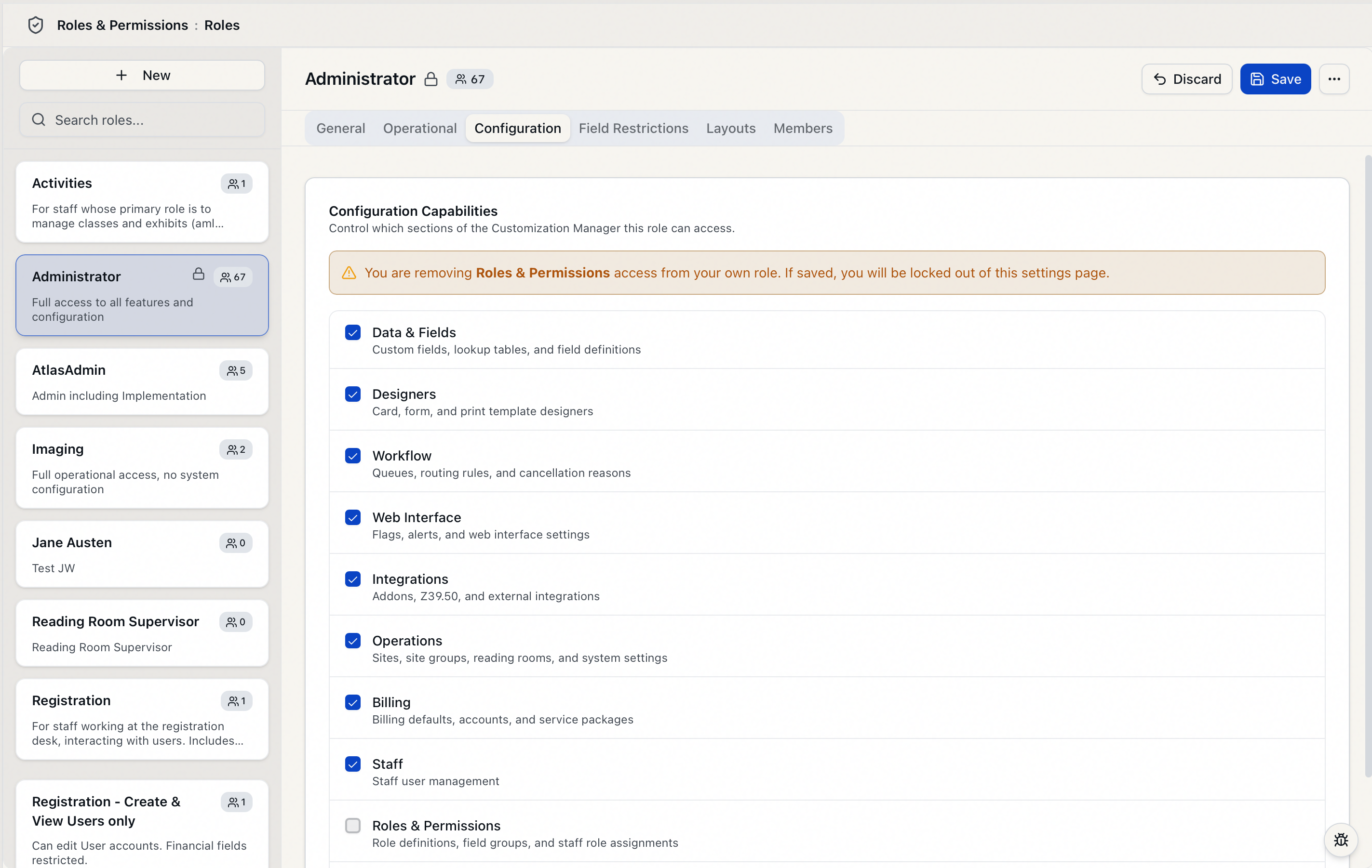 The role editor Configuration tab showing the amber warning that appears when you uncheck Roles and Permissions on your own role